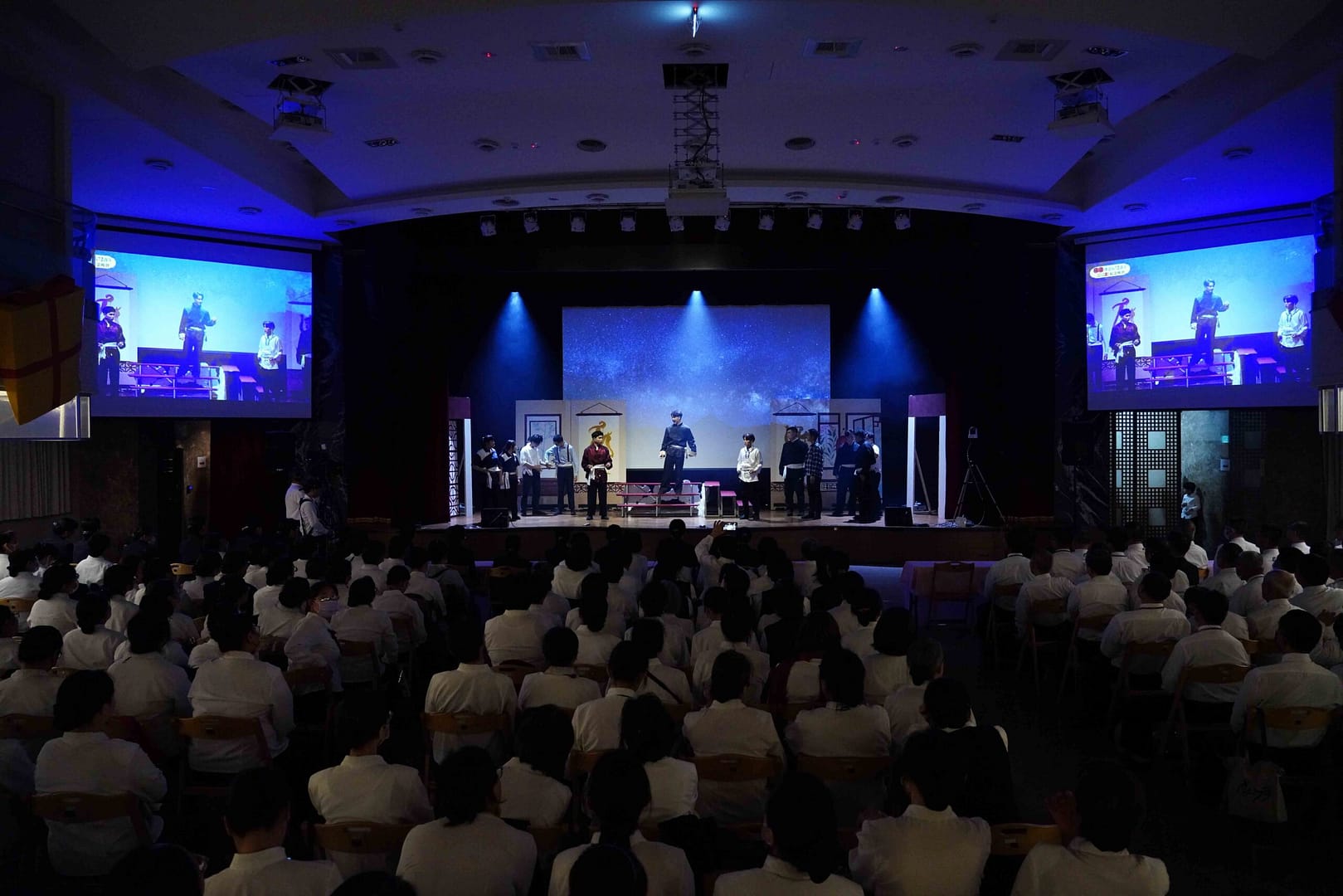 Many people in the auditorium watching the stage performance