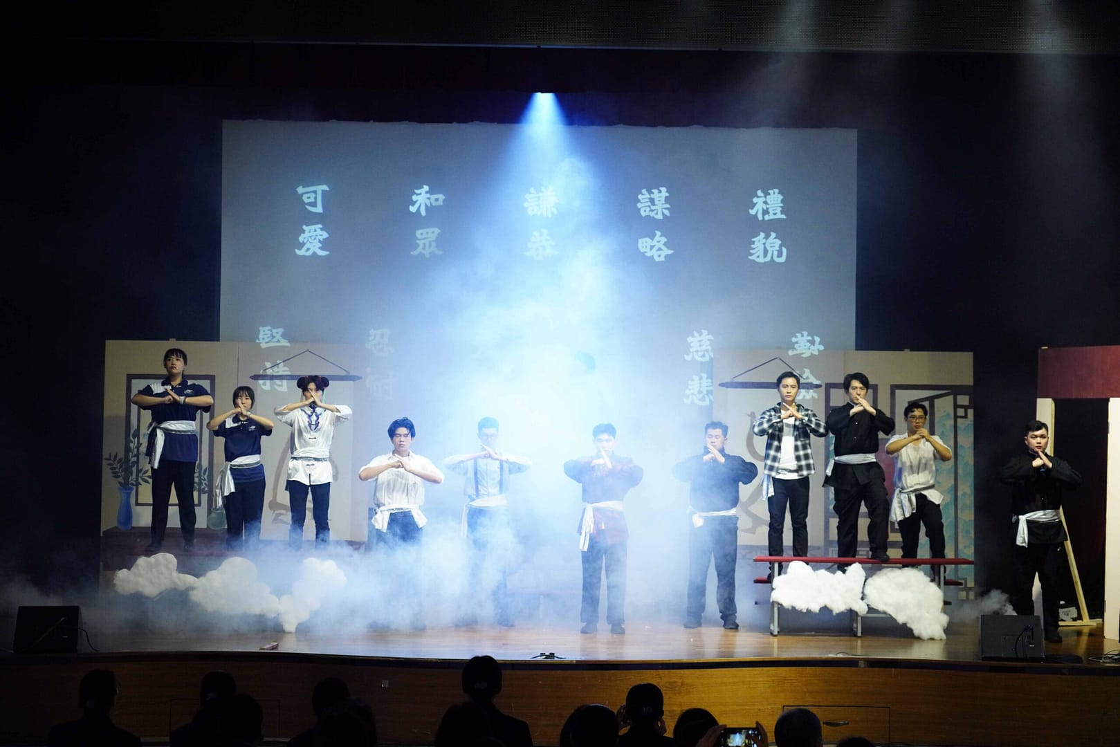 Everyone stood with fists clasped in honor