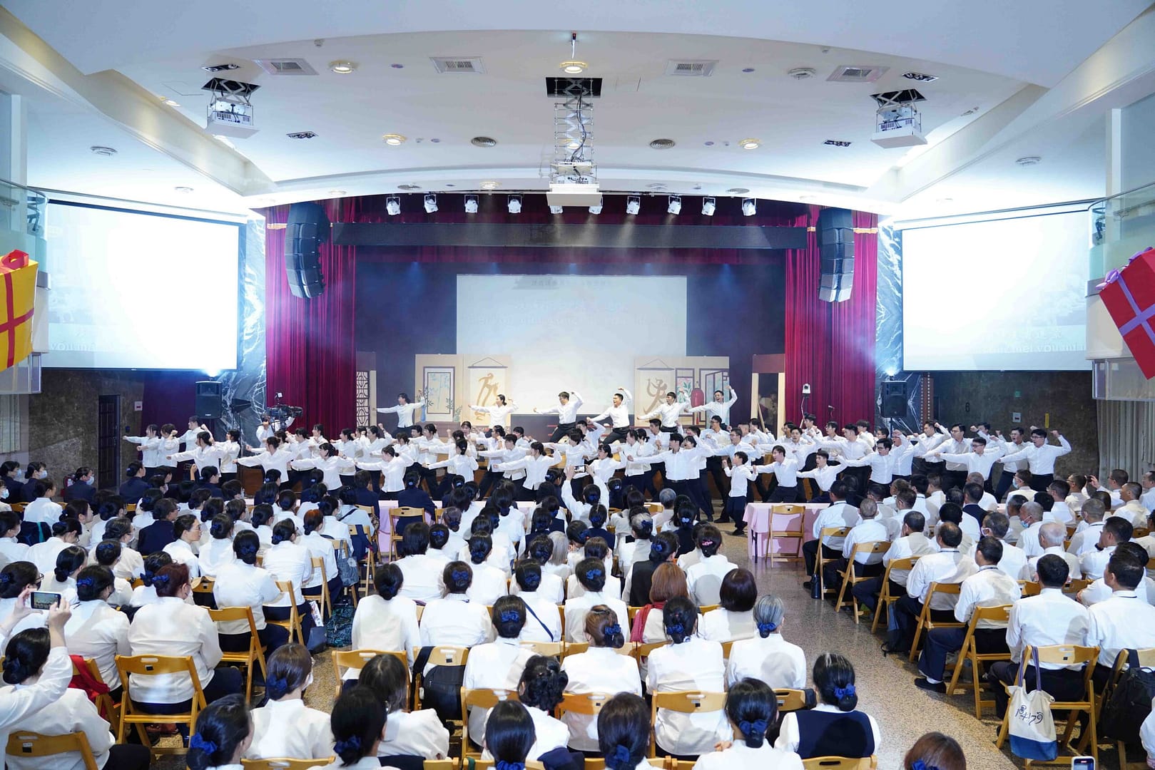 A group of Kung Fu apprentices in white clothes perform a martial arts dance together